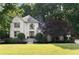 Charming two-story home features lush landscaping, a well-manicured lawn, and a stylish front entrance at 3390 River Ferry Dr, Alpharetta, GA 30022