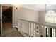 Second floor hallway overlooking a staircase and a view to the outside at 3390 River Ferry Dr, Alpharetta, GA 30022