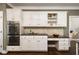 Charming kitchen featuring built in double oven and granite countertops with white cabinetry at 3390 River Ferry Dr, Alpharetta, GA 30022
