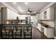 Charming kitchen features granite counters, stainless appliances, seating at bar, and hardwood flooring at 3390 River Ferry Dr, Alpharetta, GA 30022