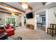 Spacious living room featuring exposed beams, an accent wall, and neutral carpeting at 3390 River Ferry Dr, Alpharetta, GA 30022