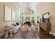 Bright living room with soaring ceilings, a fireplace, and large windows overlooking a green backyard at 3390 River Ferry Dr, Alpharetta, GA 30022
