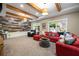 Cozy living room featuring exposed beams, a decorative accent wall, and neutral carpeting at 3390 River Ferry Dr, Alpharetta, GA 30022