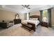 Spacious main bedroom features large bed, bench seat, bedside tables, seating and carpeted flooring at 3390 River Ferry Dr, Alpharetta, GA 30022