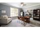 Inviting home office with natural light, cozy armchair, neutral gray walls, and stylish decorations at 3390 River Ferry Dr, Alpharetta, GA 30022