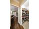 View of a fully stocked pantry with white tile flooring and open shelving for optimal storage at 3390 River Ferry Dr, Alpharetta, GA 30022