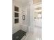 Modern tile shower features a built-in bench, shampoo niches and a stylish dark mosaic tile floor at 3390 River Ferry Dr, Alpharetta, GA 30022