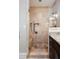 Bathroom featuring walk in shower with granite surround, rainfall shower head and glass door at 3390 River Ferry Dr, Alpharetta, GA 30022
