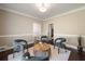 Sitting room featuring hardwood flooring, four cushioned chairs and table, and views into hall at 3390 River Ferry Dr, Alpharetta, GA 30022
