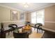 View of a sitting room with hardwood flooring and 4 cushioned chairs around a coffee table at 3390 River Ferry Dr, Alpharetta, GA 30022
