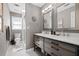 Modern bathroom with double vanity, stone countertop, and glass enclosed shower at 4527 Village Springs Run, Dunwoody, GA 30338