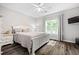 Cozy bedroom with hardwood floors, bright window, and neutral color scheme at 4527 Village Springs Run, Dunwoody, GA 30338