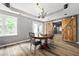Dining area with a chandelier, hardwood floors, and barn doors at 4527 Village Springs Run, Dunwoody, GA 30338