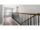 Second story hallway features wood flooring and a decorative chandelier at 4527 Village Springs Run, Dunwoody, GA 30338