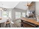 Open-concept living space connecting kitchen and living room with natural light and a stone fireplace at 4527 Village Springs Run, Dunwoody, GA 30338
