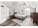 Serene main bedroom with a tray ceiling, hardwood floors, and a luxurious ensuite bathroom at 4527 Village Springs Run, Dunwoody, GA 30338