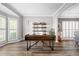 Bright home office with shuttered windows, hardwood floors, and modern desk at 4527 Village Springs Run, Dunwoody, GA 30338