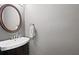 Stylish powder room with wood vanity, round mirror, and modern fixtures at 4527 Village Springs Run, Dunwoody, GA 30338