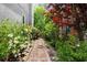 Charming walkway lined with lush greenery and colorful flowers leading to the home at 4527 Village Springs Run, Dunwoody, GA 30338