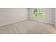 Spacious bedroom with plush carpet and natural light streaming through large windows at 7099 Brushwood Bend (Lot 32), Lithonia, GA 30058