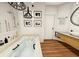 Well-lit bathroom featuring a soaking tub, stylish fixtures, and artistic wall decor, creating a spa-like retreat at 110 Serenity Pl, Fayetteville, GA 30214