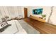 Comfortable bedroom featuring a plush bed, hardwood floors, accent chairs, and a wall-mounted TV at 110 Serenity Pl, Fayetteville, GA 30214