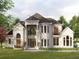 Stunning two-story home with lush landscaping, large windows, and elegant architectural details at 110 Serenity Pl, Fayetteville, GA 30214