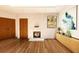 Bright living room with hardwood floors, a decorative fireplace, modern artwork, and ample natural light at 110 Serenity Pl, Fayetteville, GA 30214
