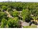 Aerial view of a property surrounded by lush green trees with a view of the city skyline in the distance at 1367 Ormewood Se Ave, Atlanta, GA 30316