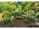 Landscaped backyard with lush greenery and hydrangeas, providing a peaceful and private outdoor retreat at 1367 Ormewood Se Ave, Atlanta, GA 30316