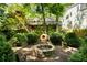 Private backyard featuring a brick fire pit, pizza oven and mature landscaping providing a secluded outdoor retreat at 1367 Ormewood Se Ave, Atlanta, GA 30316