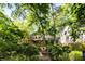 Lush backyard with outdoor pizza oven and stone pathway, offering a unique space for outdoor entertaining and relaxation at 1367 Ormewood Se Ave, Atlanta, GA 30316