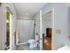 Bathroom boasts tile flooring, a shower with a curtain, and a doorway to the outside at 1367 Ormewood Se Ave, Atlanta, GA 30316