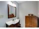 Bathroom featuring a vanity with a sink, mirror, and a storage cabinet for added convenience at 1367 Ormewood Se Ave, Atlanta, GA 30316
