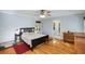 Cozy bedroom featuring hardwood floors, a ceiling fan, and natural light from the window at 1367 Ormewood Se Ave, Atlanta, GA 30316