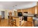 Modern kitchen features wooden cabinets, stainless steel appliances and an eat-in island at 1367 Ormewood Se Ave, Atlanta, GA 30316