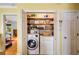 Laundry area inside closet with washer and dryer and shelving at 1367 Ormewood Se Ave, Atlanta, GA 30316
