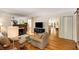 Bright living room with hardwood floors, fireplace, mirror wall, and a view of kitchen at 1367 Ormewood Se Ave, Atlanta, GA 30316