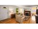 Cozy living room featuring hardwood floors, neutral furniture, and an elegant fireplace at 1367 Ormewood Se Ave, Atlanta, GA 30316