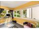 Bright sunroom with yellow walls, large windows, and a view of the lush backyard at 1367 Ormewood Se Ave, Atlanta, GA 30316