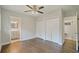 Bedroom with hardwood floors, a ceiling fan, and closet doors at 2049 Rector Sw Dr, Atlanta, GA 30311