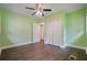 Bedroom with green walls, hardwood floors and closet doors at 2049 Rector Sw Dr, Atlanta, GA 30311