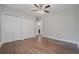 Bedroom featuring hardwood floors, closet doors and access to an ensuite bathroom at 2049 Rector Sw Dr, Atlanta, GA 30311