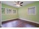 Bedroom with three windows, hardwood floors, and a ceiling fan at 2049 Rector Sw Dr, Atlanta, GA 30311