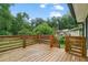 A wooden deck with wooden railings, overlooking a yard surrounded by lush greenery and trees at 2049 Rector Sw Dr, Atlanta, GA 30311