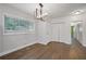 The dining room showcases hardwood floors, a modern chandelier, and an abundance of natural light at 2049 Rector Sw Dr, Atlanta, GA 30311