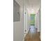 Hallway with hardwood floors and a light fixture, leading to a bright green painted room at 2049 Rector Sw Dr, Atlanta, GA 30311