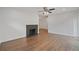 Inviting living room with fireplace and hardwood floors that extend into the entryway and dining area at 2049 Rector Sw Dr, Atlanta, GA 30311