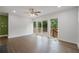 Bright living room with hardwood floors, access to a deck, and large windows offering natural light at 2049 Rector Sw Dr, Atlanta, GA 30311