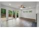 Bright living room with hardwood floors, access to a deck, and large windows offering natural light at 2049 Rector Sw Dr, Atlanta, GA 30311
